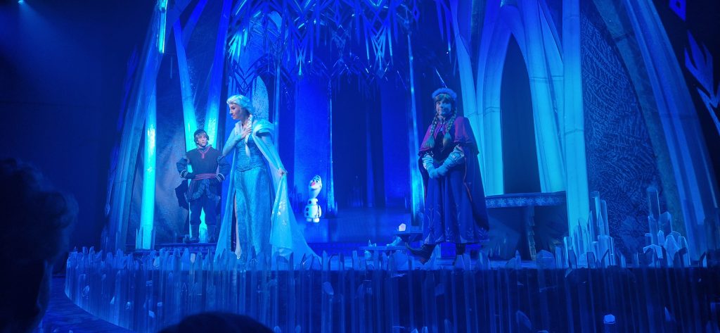 Kristoff, Anna and Elsa at the Ice Castle with Elsa singing Let it Go!